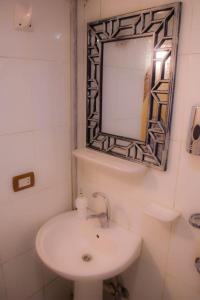a bathroom with a sink and a mirror at Floating Hotel- Happy Nile Boat in Luxor