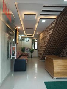 a lobby with a couch and a staircase in a building at Brajrani Hotel in Datia