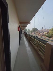 a corridor of a building with a view of a bridge at Brajrani Hotel in Datia