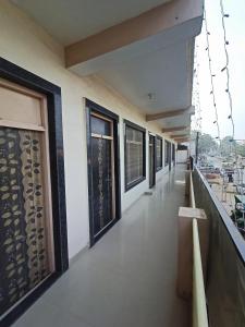 a corridor of a building with windows and a balcony at Brajrani Hotel in Datia