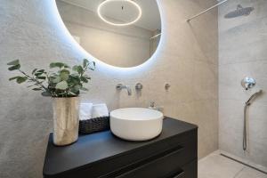 a bathroom with a sink and a mirror at Tina's Tiny Beach House in Slatine +17 photos