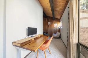 a home office with a wooden desk and a television at Kingswood Pines in Kings Beach