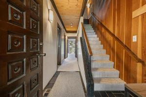 a hallway with stairs and a wooden door at Kingswood Pines in Kings Beach +4 photos