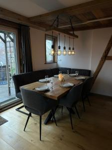a dining room with a wooden table and chairs at Tante Hanna in Winterberg