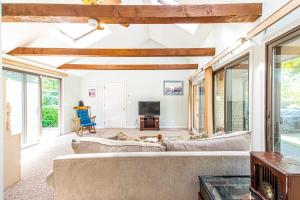 een woonkamer met banken en een tv bij Spacious Home w Finished Game Room in Eastham