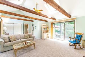 een woonkamer met een bank en een tafel bij Spacious Home w Finished Game Room in Eastham