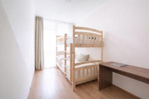 a room with a bunk bed and a desk at Comfort 66 Large Family City Home in Miskolc