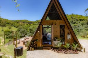 una grande casa in legno con una grande finestra di Chale Alcantara Jacuzzi, Lareira e Deck com Vista a São Pedro de Alcântara