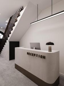 an office with a reception desk and a staircase at JM Central Boutique Hotel in Baku