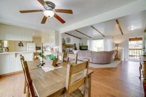 een keuken en een woonkamer met een tafel en een plafondventilator bij 30-Acre Witter Springs Ranch with Barn and Views! in Upper Lake