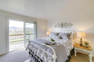 een slaapkamer met een bed en een groot raam bij 30-Acre Witter Springs Ranch with Barn and Views! in Upper Lake