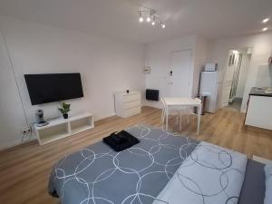 Cette grande chambre blanche dispose d'un lit et d'une télévision à écran plat. dans l'établissement BudgetBnb 281, downtown studio, à La Seyne-sur-Mer