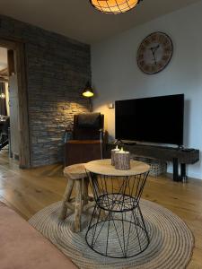 a living room with a table and a flat screen tv at Tante Hanna in Winterberg