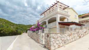 a building with flowers on a stone wall at Villa Vanilla by Villas Guide in Smokvica