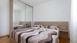 a bedroom with two beds and a large mirror at Villa Vanilla by Villas Guide in Smokvica +26 photos