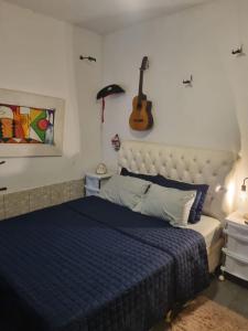 En eller flere senge i et værelse på Kitnets do Jota