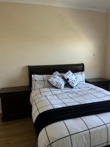 a bed with two pillows on top of it at Sleep easy at Peperboom in Kuilsrivier