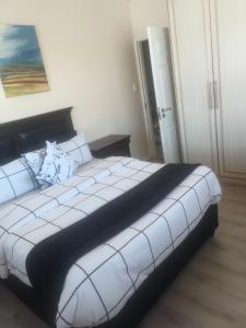 a bedroom with a large white bed in a room at Sleep easy at Peperboom in Kuilsrivier +1 photo