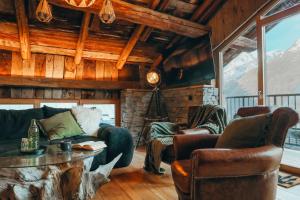 a living room with a couch and a table at Chalet du cerf fragment in Saint-Martin-de-Belleville