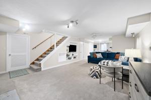 a living room with a blue couch and stairs at Nanas Nook on Hickory Grove in Clarksville