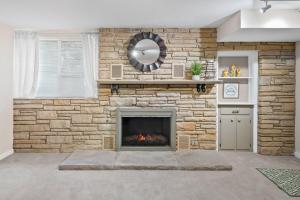 a stone wall with a fireplace in a living room at Nanas Nook on Hickory Grove in Clarksville +27 photos