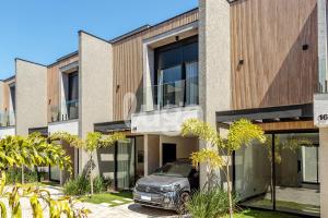 a car parked in front of a building at LUGA Relax House with Jacuzzi in Palhoça