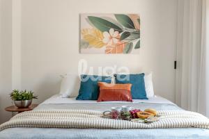 a bed with a tray of food on it at LUGA Relax House with Jacuzzi in Palhoça