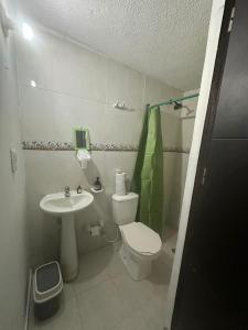 a small bathroom with a toilet and a sink at FAMILY HOUSE CN in Cali