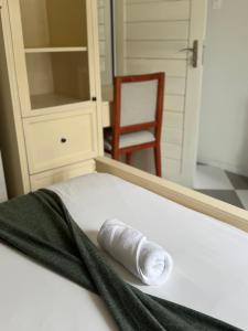 a white shoe sitting on a bed in a room at Peter's Nest in Livingstone