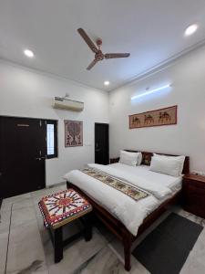 a bedroom with a bed and a ceiling fan at Riga House in Udaipur