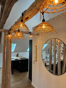 a room with a mirror and some lights at Résidence ARTHUS Thamarys in Pierrefonds