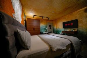 a bedroom with a bed with a sign on the wall at Cappadocia Divin House in Goreme