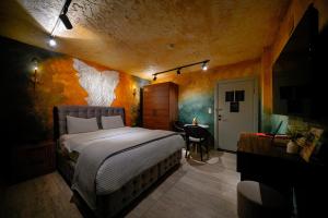 a bedroom with a large bed and a table at Cappadocia Divin House in Goreme
