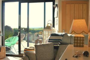 a living room with a couch and a large window at Mill View Cottage- charming coastal cottage in Saint Monance