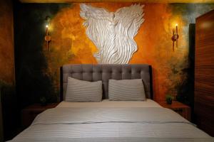 a bedroom with a bed with a wooden cross on the wall at Cappadocia Divin House in Goreme +212 photos