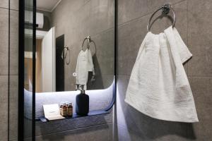 a bathroom with a white towel hanging on a wall at Astor Wellness apartman in Belgrade +11 photos