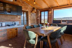 a kitchen and dining room with a wooden table and chairs at Lazarica in Divoš