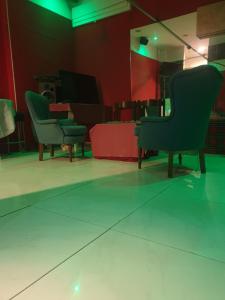 a room with chairs and a table in a room at Mini Hostel 404 in Turin +2 photos