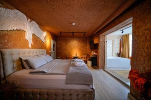 a bedroom with a large bed in a room at Cappadocia Divin House in Göreme