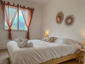a large white bed in a bedroom with a mirror at Liberté Prestige - Tram - Rocade in Fontaine