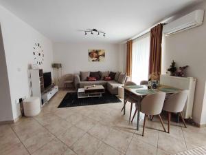 a living room with a couch and a table at PERLA apartment in Alexandroupoli