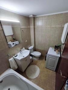 a bathroom with a sink and a toilet and a tub at PERLA apartment in Alexandroupoli +34 photos