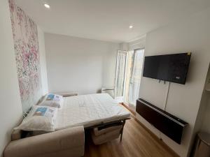 a bedroom with a bed and a flat screen tv at Hello sunshine nice in Nice +4 photos