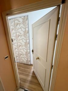 an open door leading to a room with a wall at Hello sunshine nice in Nice
