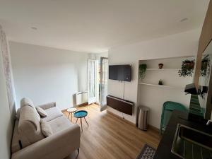 a living room with a couch and a flat screen tv at Hello sunshine nice in Nice