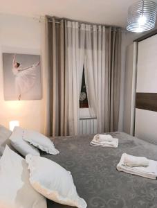 a bedroom with two beds with a ballet dancer on the wall at Nektar 88 in Vrnjačka Banja