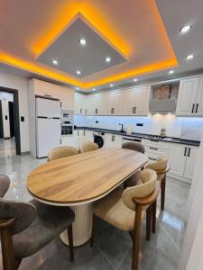 a kitchen with a wooden table and chairs at Apartmarsala in Ovaköy