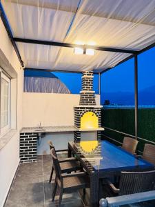 a patio with a table and chairs under awning at Apartmarsala in Ovaköy +4 photos