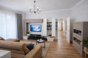 a living room with a couch and a table at Liqeni New Apartament in Tirana