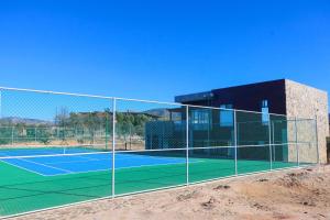 a tennis court in front of a building at Siempre Valle Hotel Boutique in Valle de Guadalupe